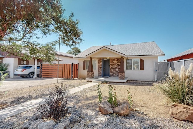 1139 Forrester Ave NW, Albuquerque, NM 87104 - ranch-style home with a porch, a gate, fence, driveway, and stucco siding