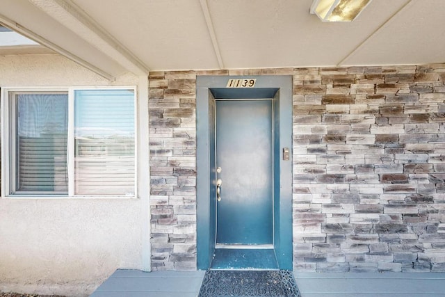 1139 Forrester Ave NW, Albuquerque, NM 87104 - view of exterior entry featuring elevator and stone siding