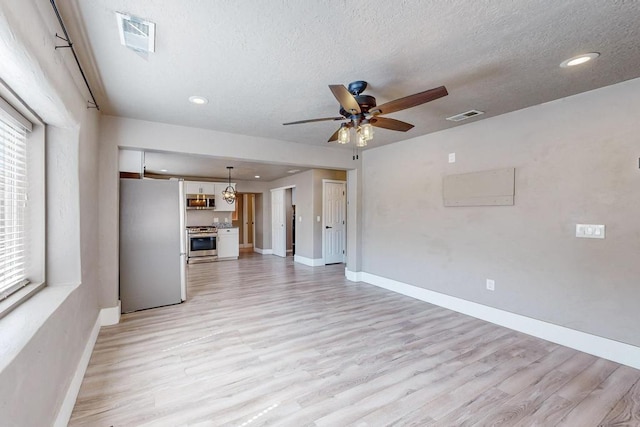 1139 Forrester Ave NW, Albuquerque, NM 87104 - unfurnished living room with visible vents, baseboards, ceiling fan, light wood-style floors, and recessed lighting