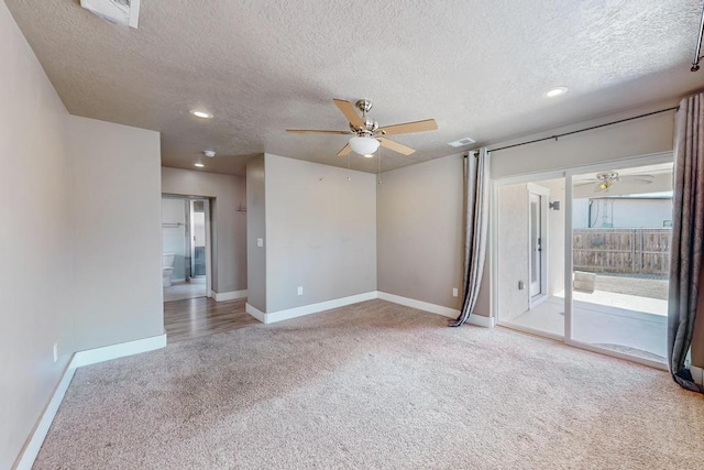 carpeted empty room with ceiling fan and a textured ceiling