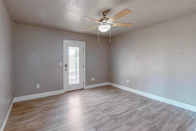 spare room featuring ceiling fan, a textured ceiling, and light hardwood / wood-style flooring