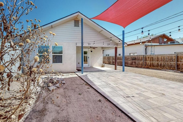 1139 Forrester Ave NW, Albuquerque, NM 87104 - rear view of house featuring a patio, stucco siding, fence, and a ceiling fan
