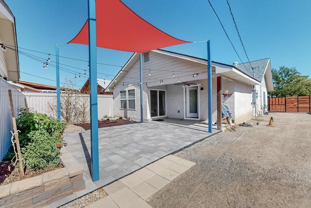 1139 Forrester Ave NW, Albuquerque, NM 87104 - back of property featuring a fenced backyard, a patio area, stucco siding, and a ceiling fan