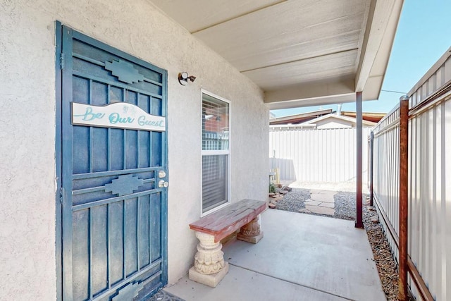 1139 Forrester Ave NW, Albuquerque, NM 87104 - view of exterior entry featuring fence and stucco siding