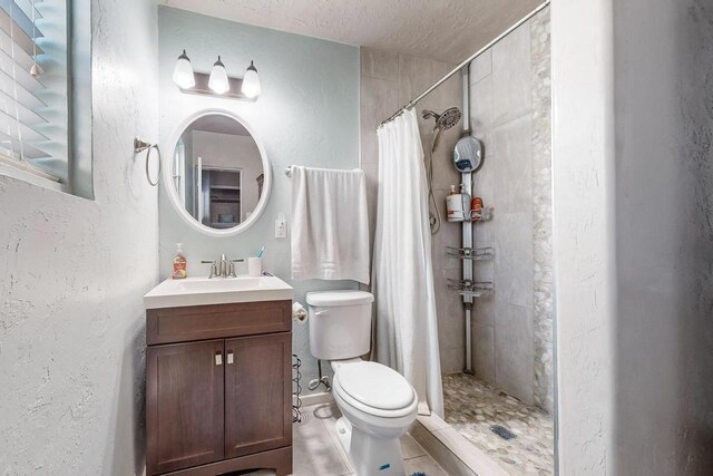 1139 Forrester Ave NW, Albuquerque, NM 87104 - bathroom featuring toilet, a textured ceiling, tile patterned flooring, a textured wall, and tiled shower