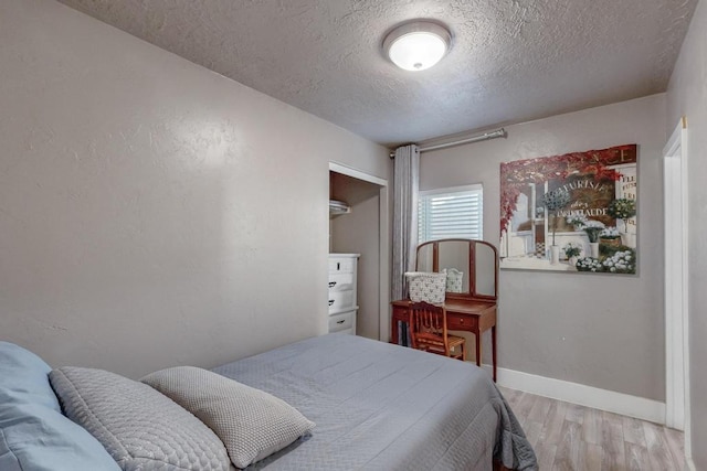 1139 Forrester Ave NW, Albuquerque, NM 87104 - bedroom with baseboards, light wood-type flooring, and a textured ceiling