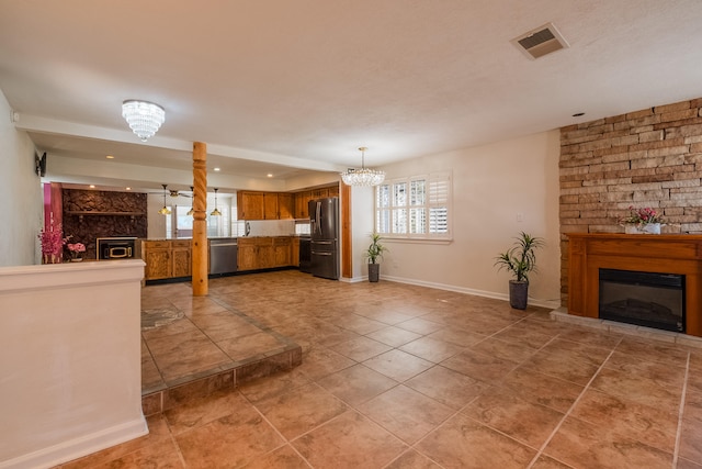 unfurnished living room with a notable chandelier and tile patterned flooring