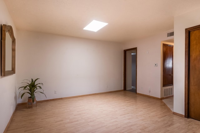 spare room featuring light hardwood / wood-style flooring