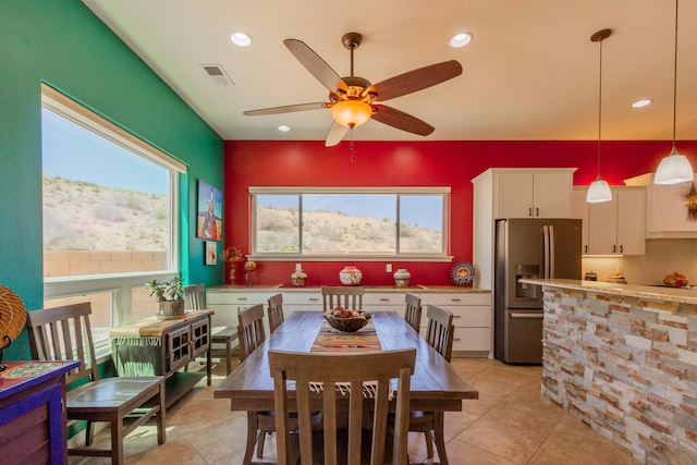 tiled dining space featuring ceiling fan