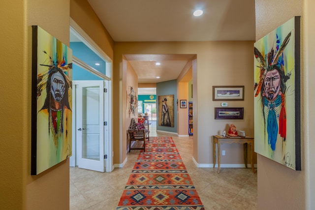 corridor with light tile patterned floors, french doors, recessed lighting, and baseboards