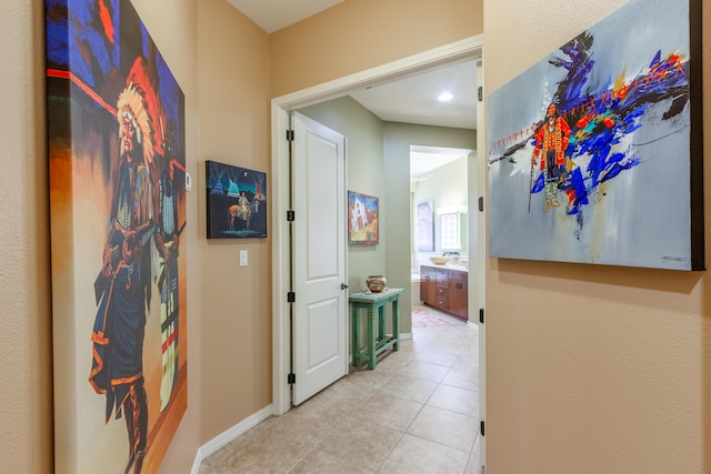 hall with light tile patterned flooring, recessed lighting, and baseboards