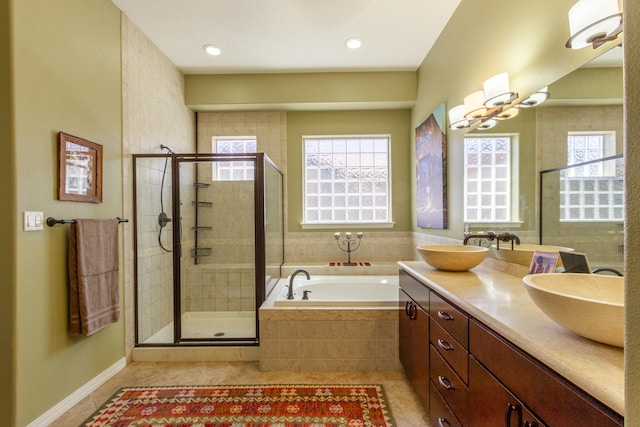 bathroom featuring vanity, a healthy amount of sunlight, tile patterned floors, and shower with separate bathtub