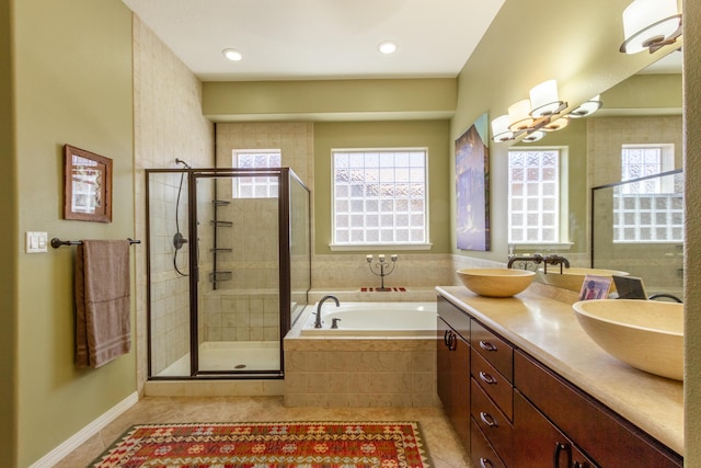 bathroom featuring a healthy amount of sunlight, a shower stall, a bath, and tile patterned flooring