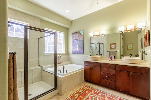 bathroom with vanity, independent shower and bath, a healthy amount of sunlight, and tile patterned flooring