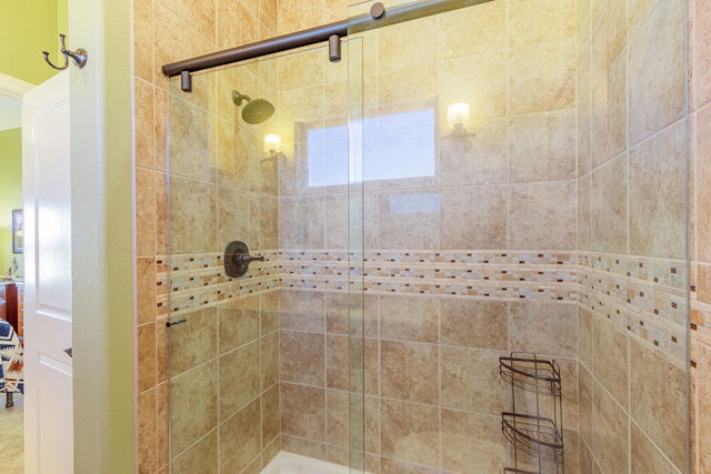 bathroom featuring a shower with door