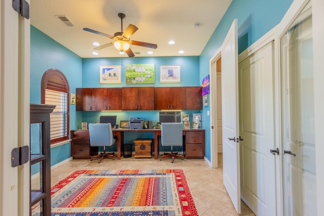 home office with light tile patterned floors, built in desk, ceiling fan, visible vents, and french doors