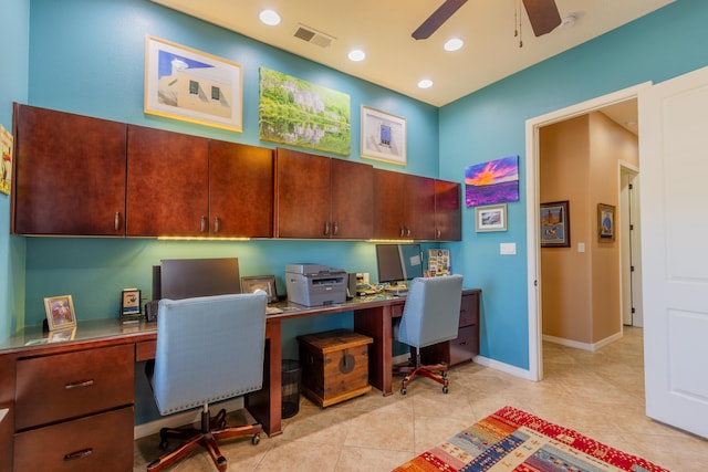 tiled office space with built in desk and ceiling fan