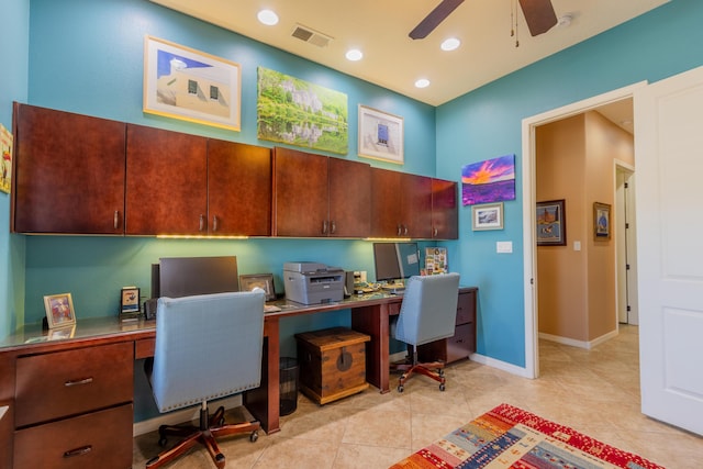 office space with visible vents, a ceiling fan, light tile patterned flooring, and built in desk
