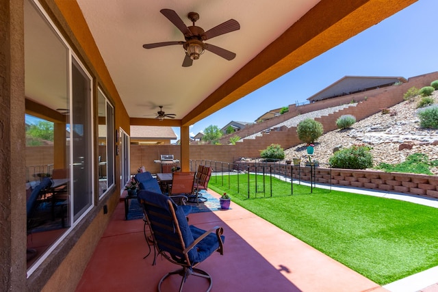 view of patio featuring a fenced backyard, a ceiling fan, and outdoor dining area