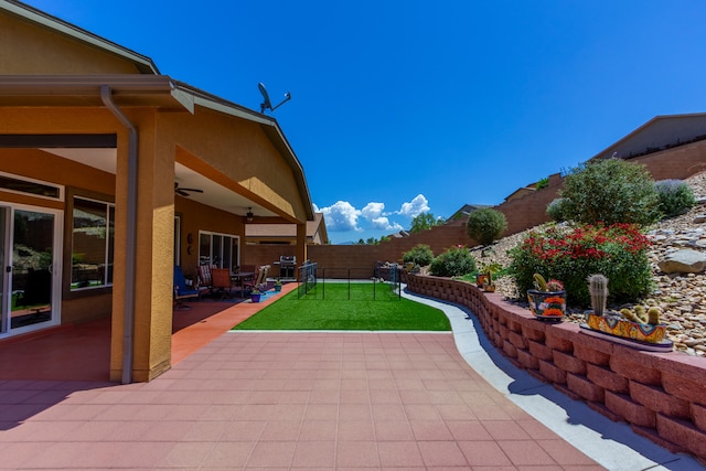 view of swimming pool featuring area for grilling, a patio area, a lawn, and ceiling fan