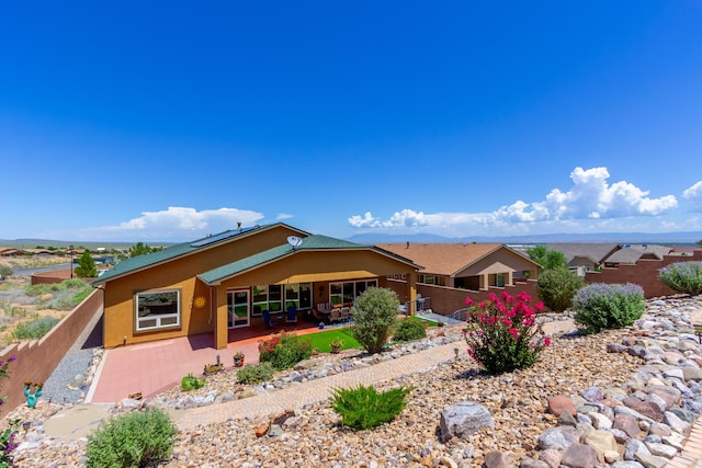 back of house featuring fence, stucco siding, and a patio area
