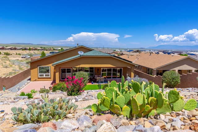 view of front facade featuring a patio area and a mountain view