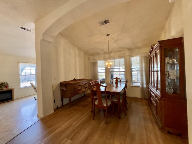 dining area featuring hardwood / wood-style floors and a chandelier