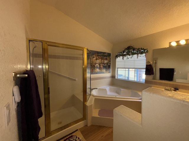 bathroom with plus walk in shower, lofted ceiling, hardwood / wood-style floors, and a textured ceiling