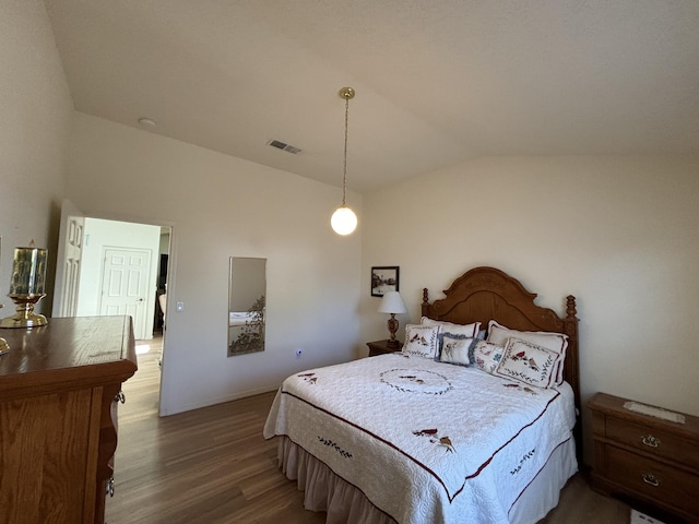 bedroom with hardwood / wood-style flooring and vaulted ceiling