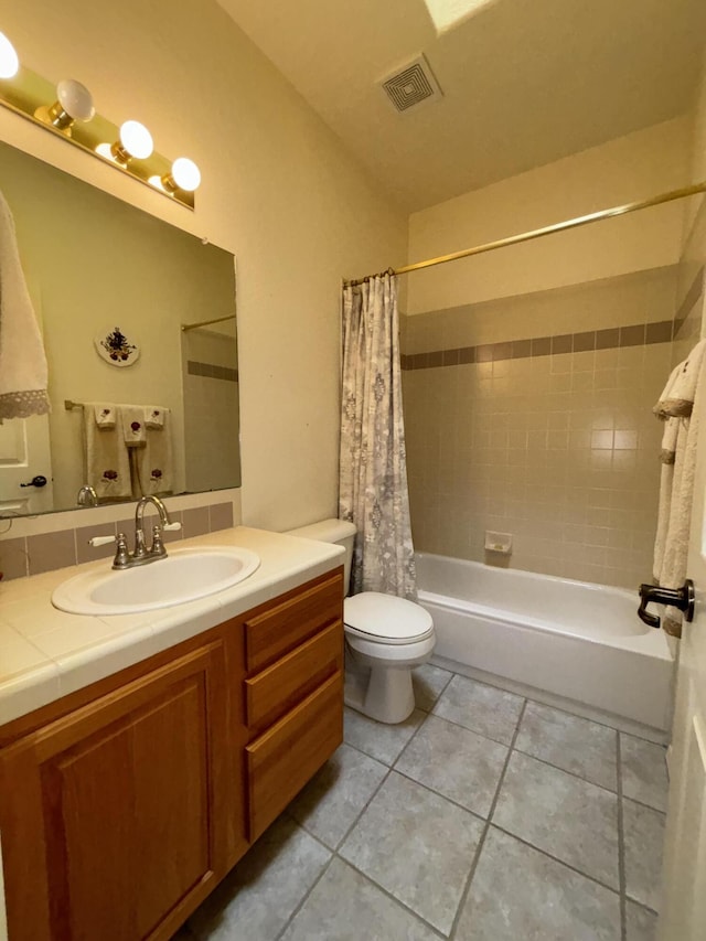 full bathroom with vanity, shower / bath combination with curtain, tile patterned floors, and toilet