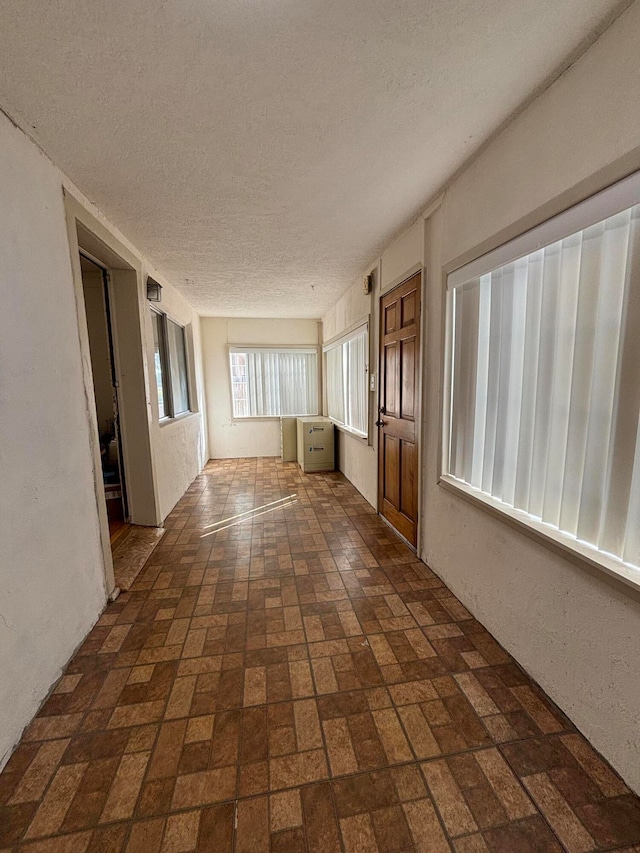 spare room with a textured ceiling