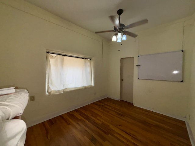 interior space with ceiling fan and dark hardwood / wood-style floors