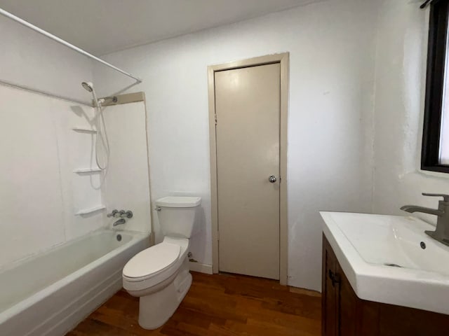 full bathroom featuring shower / bathtub combination, hardwood / wood-style floors, vanity, and toilet