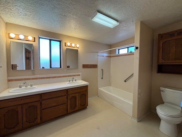 full bathroom with vanity, a textured ceiling, shower / bath combination, and toilet