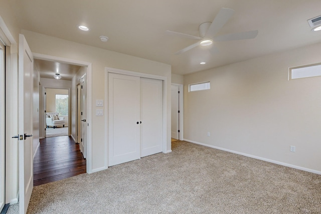 unfurnished bedroom featuring hardwood / wood-style flooring, a closet, and ceiling fan