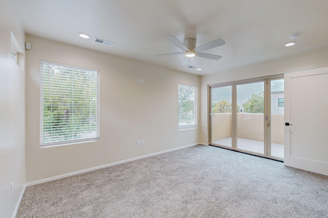 unfurnished bedroom with light colored carpet, access to outside, and ceiling fan