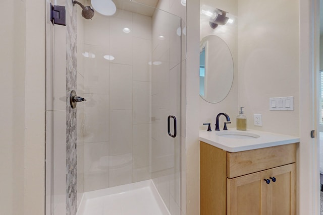 bathroom with vanity and a shower with shower door