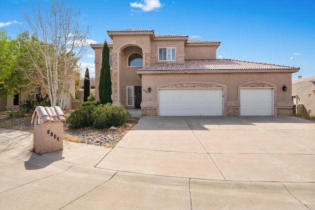 mediterranean / spanish-style house with a garage