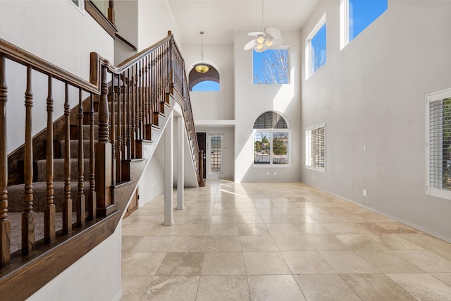 entryway with a high ceiling and a notable chandelier