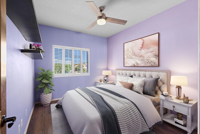 bedroom with ceiling fan, hardwood / wood-style floors, and a textured ceiling