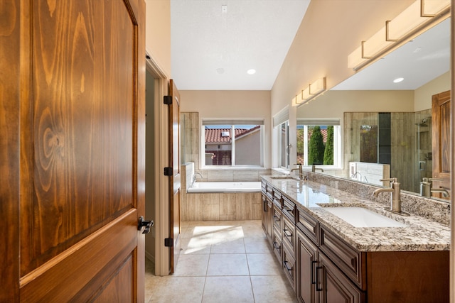 bathroom featuring tile patterned floors, plus walk in shower, vanity, and lofted ceiling