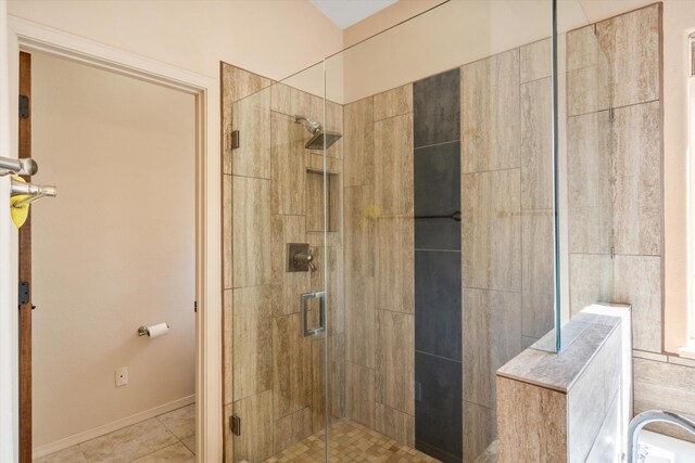 bathroom featuring tile patterned floors and a shower with door