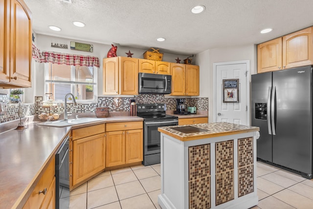 kitchen with light tile patterned floors, appliances with stainless steel finishes, and a wealth of natural light