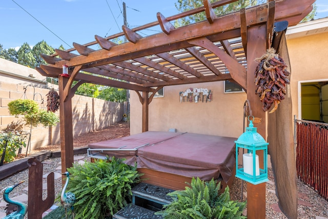 wooden deck featuring a pergola and a hot tub