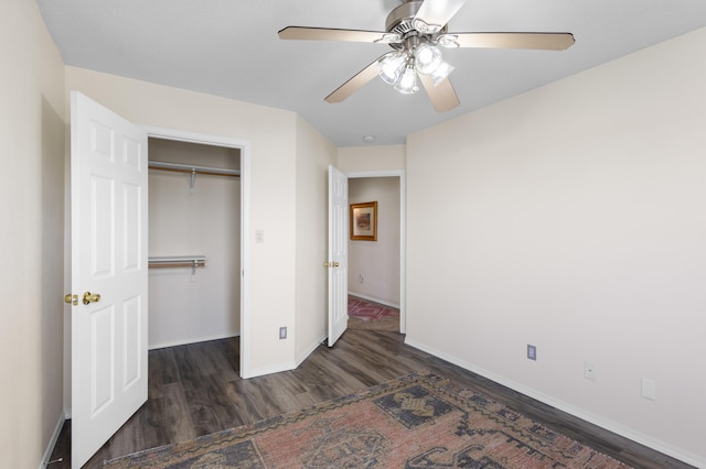 unfurnished bedroom featuring a closet, ceiling fan, and dark hardwood / wood-style flooring