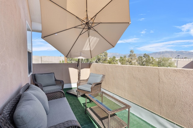 balcony featuring an outdoor living space and a mountain view