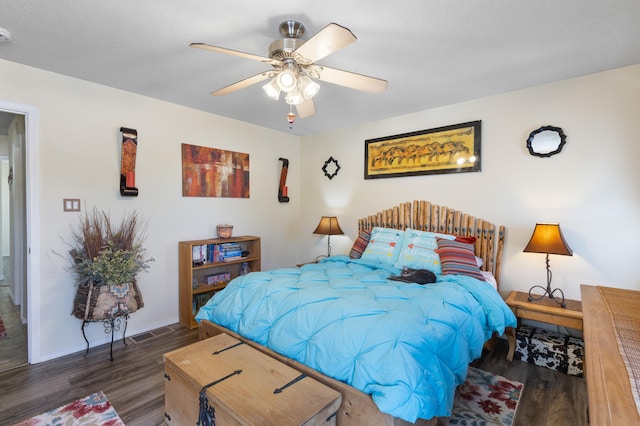 bedroom featuring a textured ceiling, dark wood-type flooring, and ceiling fan