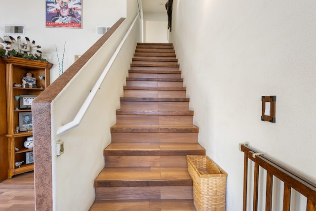 stairs with hardwood / wood-style flooring