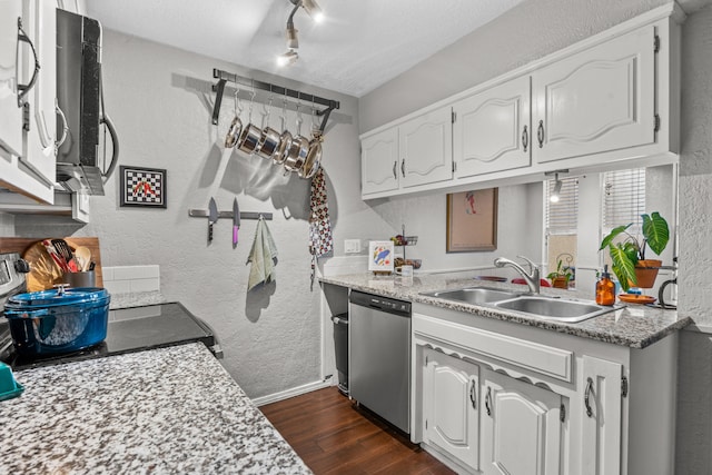 kitchen featuring appliances with stainless steel finishes, white cabinets, and sink