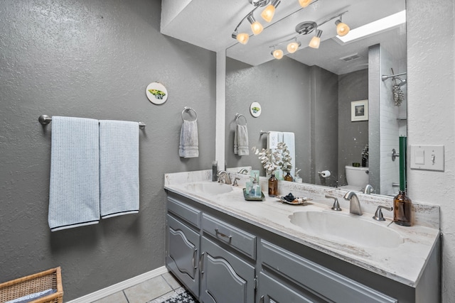 bathroom with vanity, toilet, and tile patterned flooring